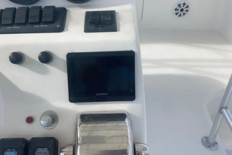 Slide: The Image of Control panel of 2000 Luhrs Tournament 360 Convertible with Garmin display and switches. - 27