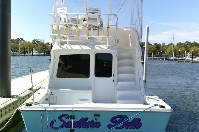 Slide: The Image of 2000 Luhrs Tournament 360 Convertible yacht docked, featuring upper deck seating and "Southern Belle" name. - 4