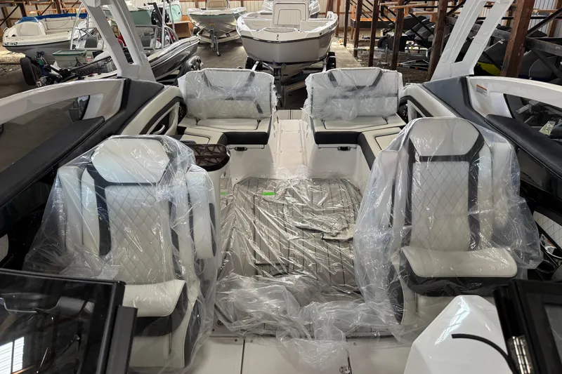 Slide: The Image of 2026 Yamaha Boats 275SD interior with protective plastic covers in a showroom setting. - 11