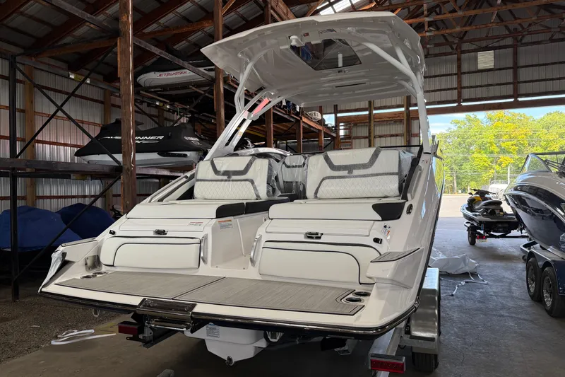 Slide: The Image of 2026 Yamaha Boats 275SD in storage, showcasing sleek design and spacious seating. - 2