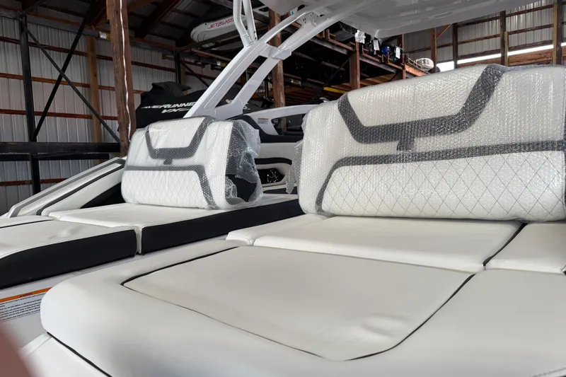 Slide: The Image of 2026 Yamaha Boats 275SD interior with cushioned seating in a storage facility. - 6