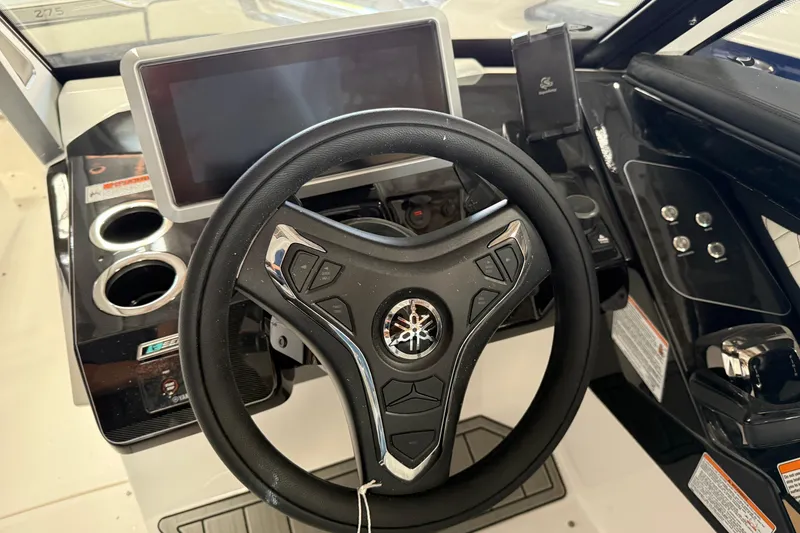 Slide: The Image of 2026 Yamaha Boats 275SD steering wheel and dashboard with modern controls. - 9