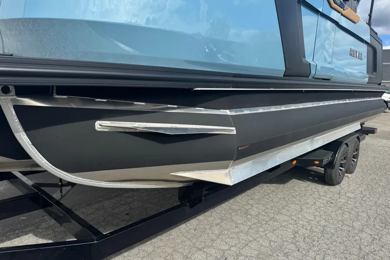 Slide: The Image of 2026 Revel RS25 boat on trailer, showcasing sleek design and modern features. - 10