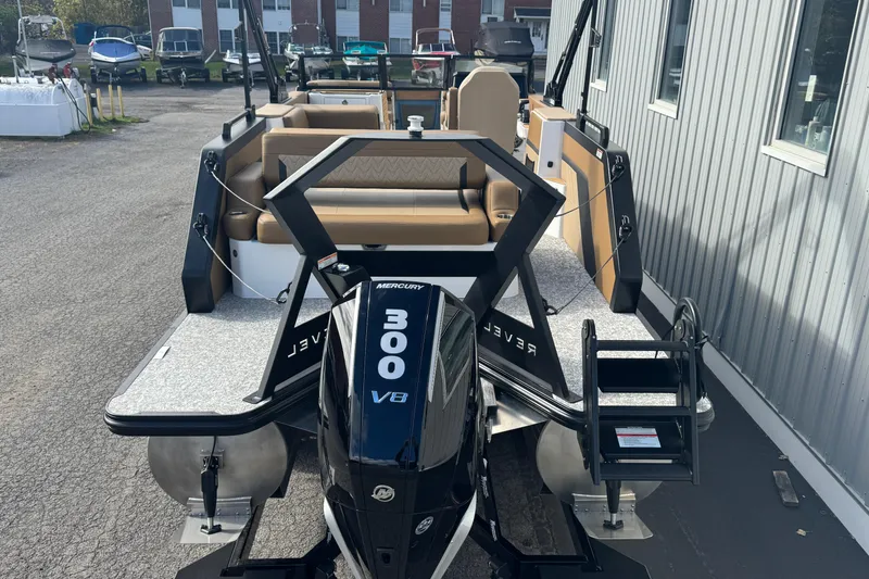 Slide: The Image of 2026 Revel RS25 boat with Mercury 300 V8 engine, docked near a building. - 15