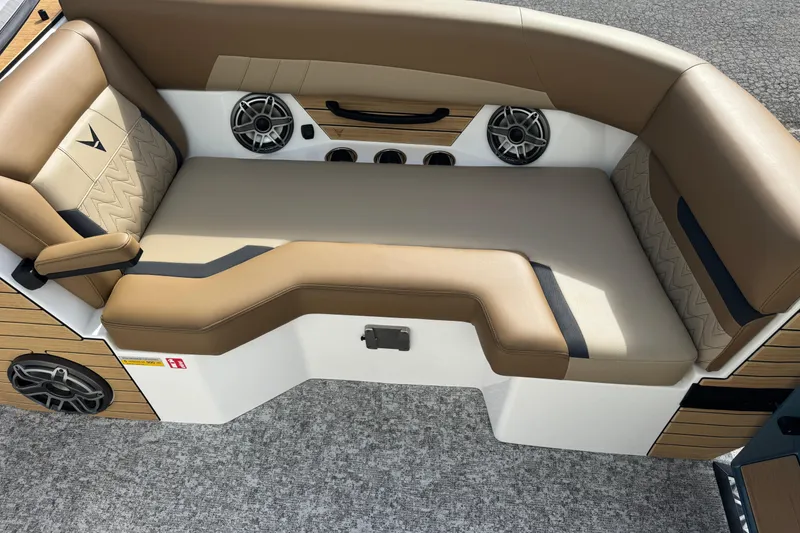 Slide: The Image of Luxurious seating area in 2026 Revel RS25 boat with tan upholstery and built-in speakers. - 18