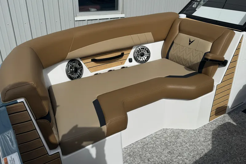 Slide: The Image of Luxurious seating area on 2026 Revel RS25 boat with tan upholstery and built-in speakers. - 19