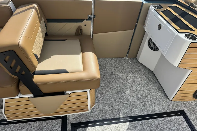 Slide: The Image of 2026 Revel RS25 boat interior with tan seating and modern console design. - 21