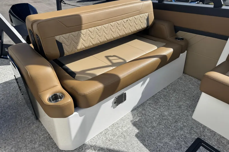 Slide: The Image of Luxurious tan seating on 2026 Revel RS25 boat, featuring cup holders and stylish design. - 23