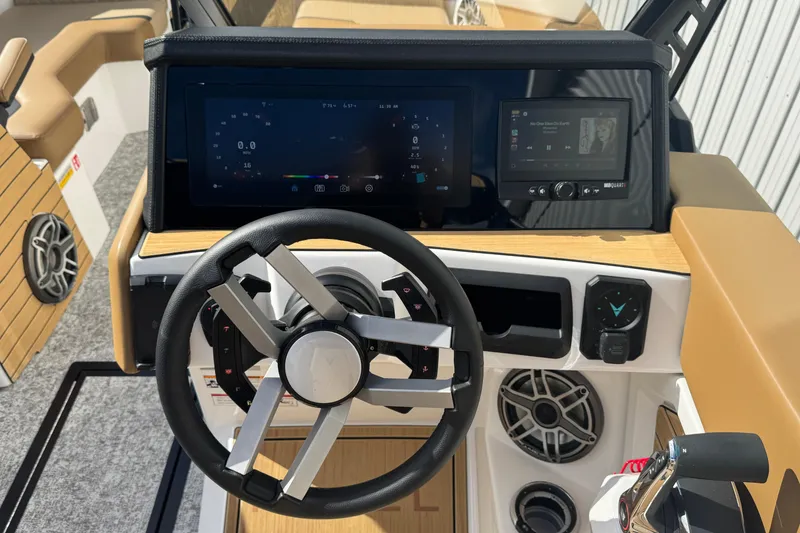 Slide: The Image of 2026 Revel RS25 boat dashboard with modern steering wheel and digital displays. - 27