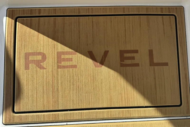 Slide: The Image of Revel RS25 2026 logo on wooden surface with shadow effect. - 28