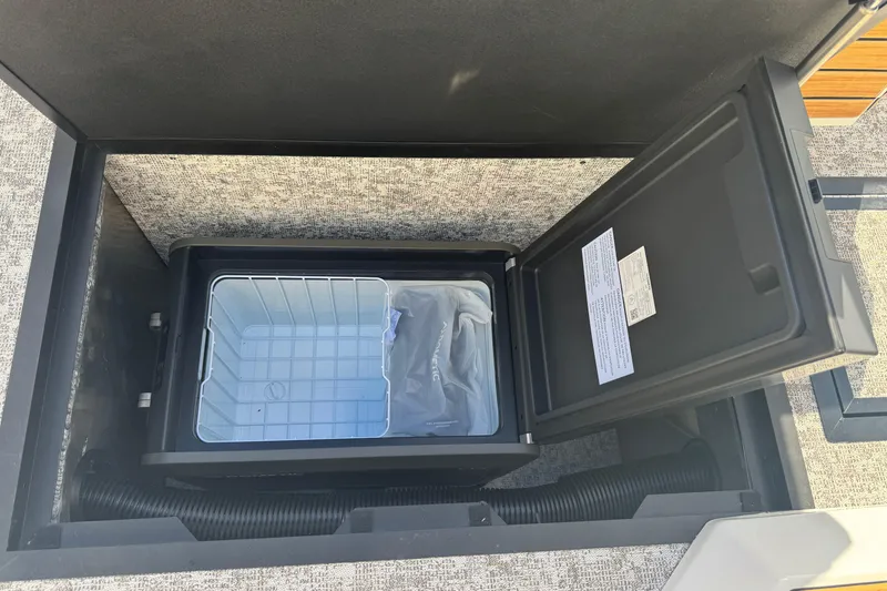 Slide: The Image of 2026 Revel RS25 storage compartment with open lid, showcasing interior space and design. - 31