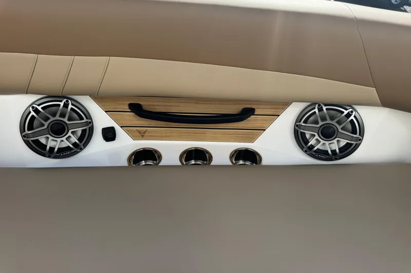 Slide: The Image of 2026 Revel RS25 interior speakers and controls with sleek design and wood accents. - 32