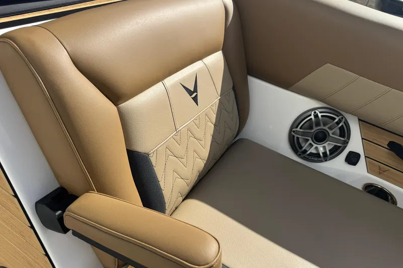 Slide: The Image of 2026 Revel RS25 boat seat with tan upholstery and built-in speaker. - 36