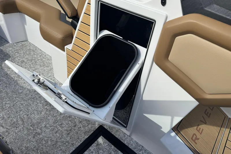 Slide: The Image of Open storage compartment on 2026 Revel RS25 boat with cushioned seating. - 38