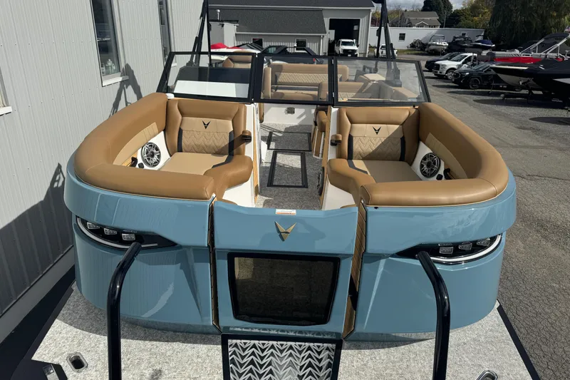 Slide: The Image of 2026 Revel RS25 boat with tan seating and modern design in a marina setting. - 8