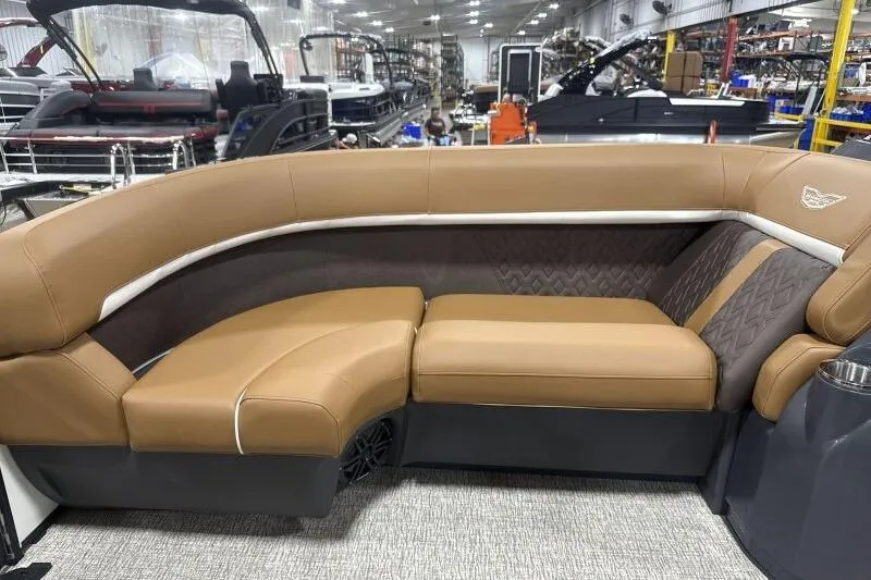 Slide: The Image of Luxurious seating on a 2026 Bennington 22 MSBSF boat, featuring tan upholstery in a showroom. - 15