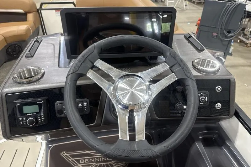 Slide: The Image of Steering console of 2026 Bennington 22 MSBSF boat with modern controls and cup holders. - 17