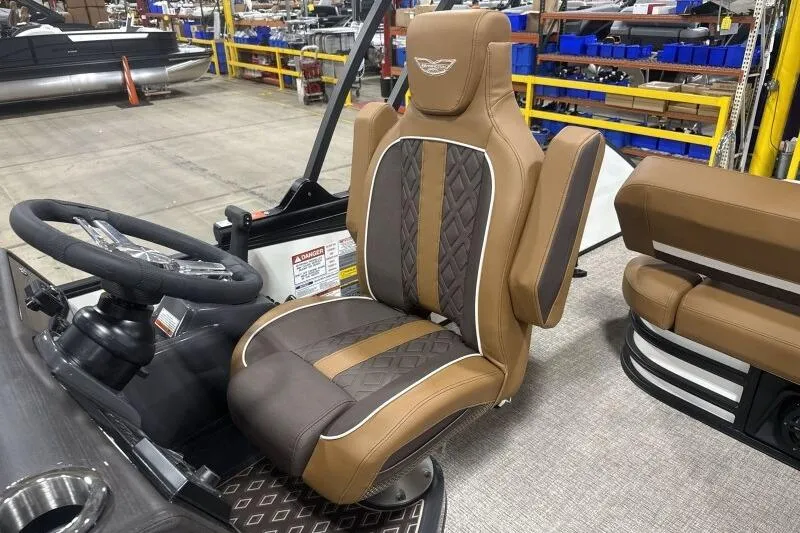 Slide: The Image of 2026 Bennington 22 MSBSF boat interior with luxurious brown captain's seat and steering wheel. - 19