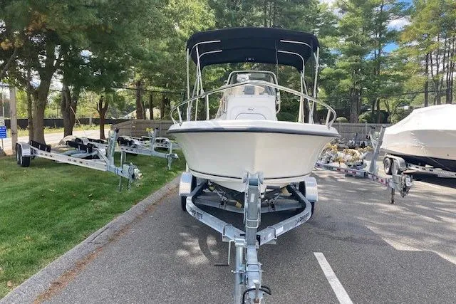 Slide: The Image of 2013 Key West 189 FS boat on trailer, parked outdoors with trees in background. - 11