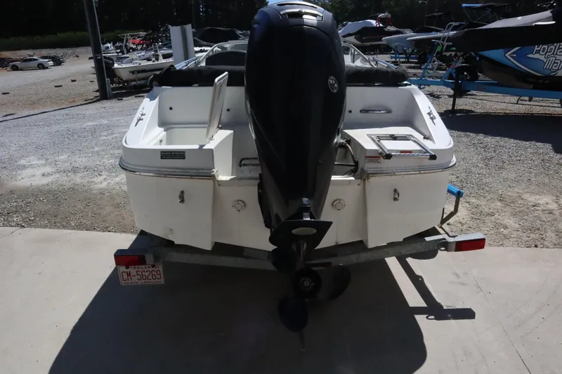 Slide: The Image of 2014 Caravelle 19 EBo Bowrider boat on trailer, rear view with outboard motor. - 1