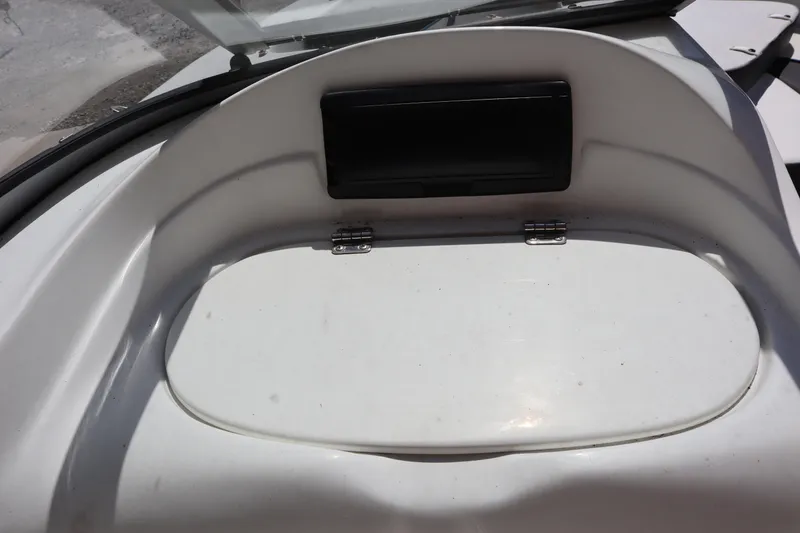 Slide: The Image of 2014 Caravelle 19 EBo Bowrider dashboard with storage compartment and windshield. - 11
