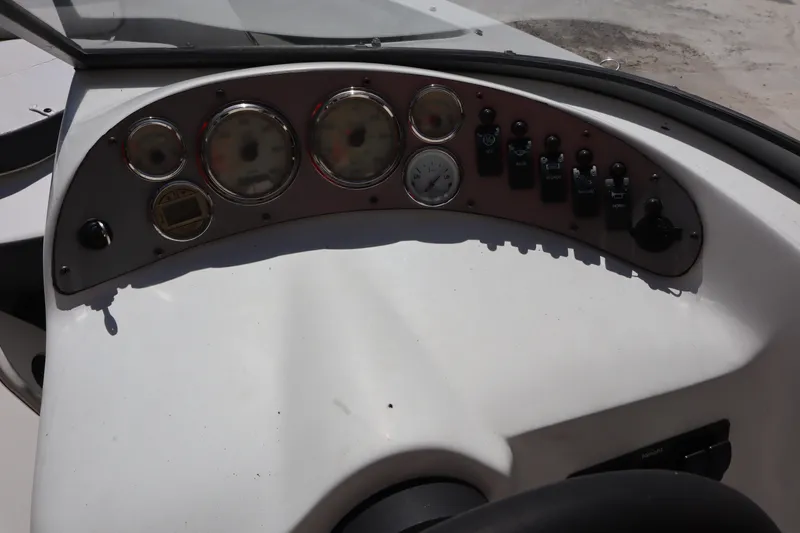 Slide: The Image of Dashboard of a 2014 Caravelle 19 EBo Bowrider boat with gauges and controls. - 13