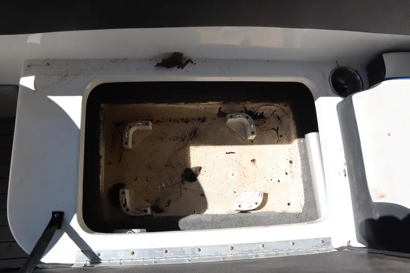 Slide: The Image of 2014 Caravelle 19 EBo Bowrider storage compartment, showing interior details and condition. - 16