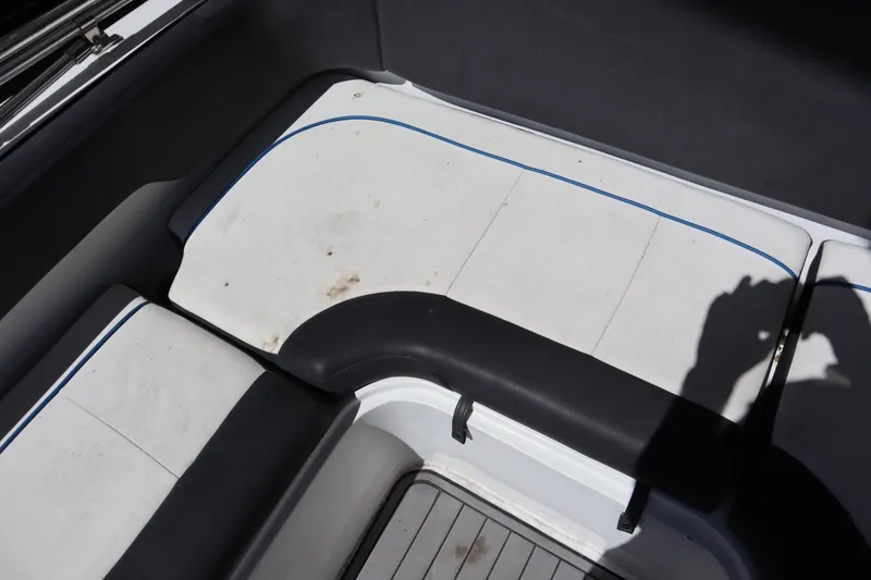 Slide: The Image of 2014 Caravelle 19 EBo Bowrider interior seating with white and black upholstery. - 17