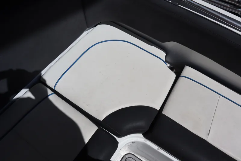 Slide: The Image of 2014 Caravelle 19 EBo Bowrider interior seating with white and black upholstery. - 19