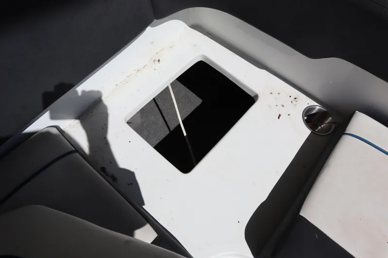 Slide: The Image of Interior view of a 2014 Caravelle 19 EBo Bowrider boat with open storage compartment. - 20