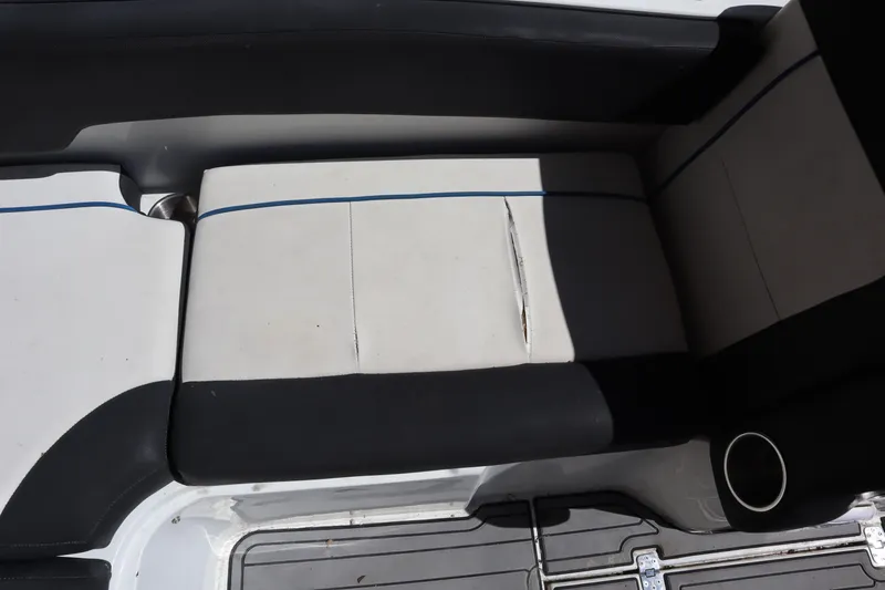 Slide: The Image of 2014 Caravelle 19 EBo Bowrider interior seating with visible tear and cup holder. - 21