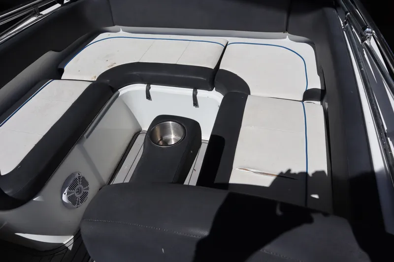 Slide: The Image of 2014 Caravelle 19 EBo Bowrider interior seating with cup holder and speaker. - 23