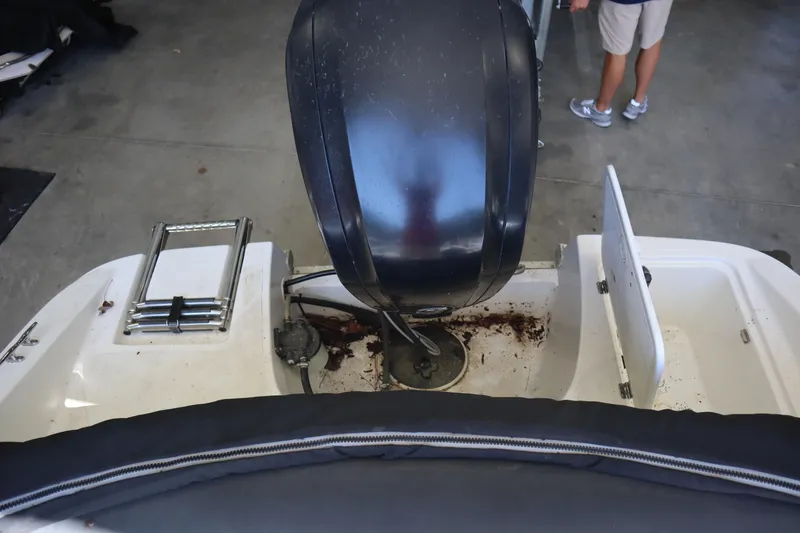 Slide: The Image of 2014 Caravelle 19 EBo Bowrider boat engine area with ladder and storage compartments. - 24