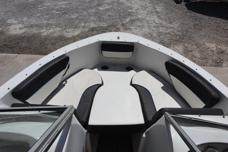Slide: The Image of 2014 Caravelle 19 EBo Bowrider boat interior with black and white seating. - 3