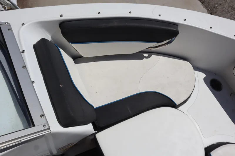 Slide: The Image of 2014 Caravelle 19 EBo Bowrider boat interior seating, black and white upholstery. - 4