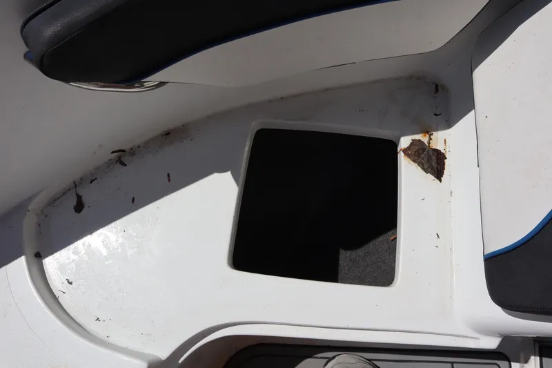 Slide: The Image of 2014 Caravelle 19 EBo Bowrider interior storage compartment with debris. - 7