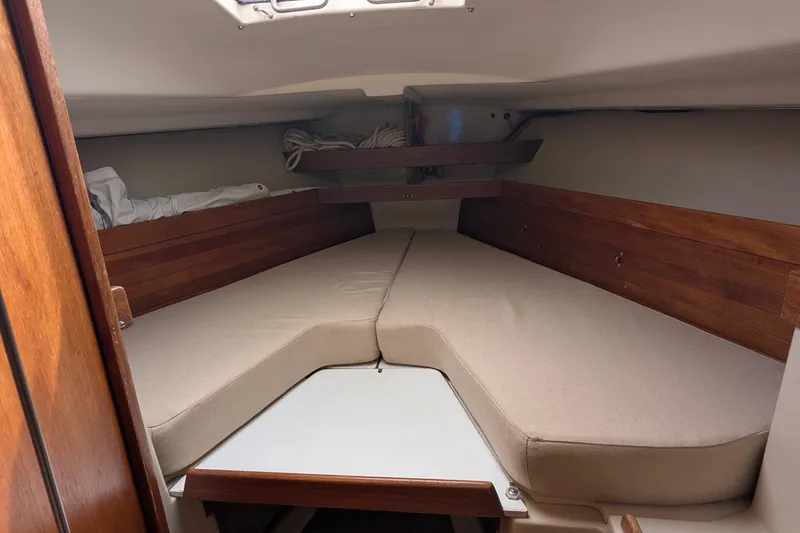 Slide: The Image of Interior of 1980 C&C 36 sailboat with cozy seating and wooden accents. - 10