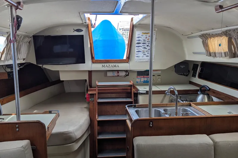 Slide: The Image of Interior of a 1980 C&C 36 sailboat, featuring a cozy cabin berth and wooden accents. - 12