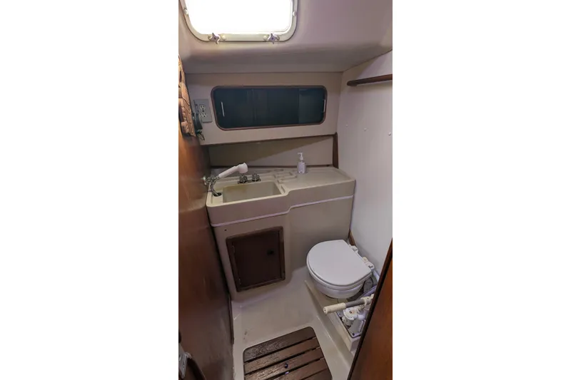 Slide: The Image of Interior cabin of 1980 C&C 36 sailboat with V-berth and wooden accents. - 13