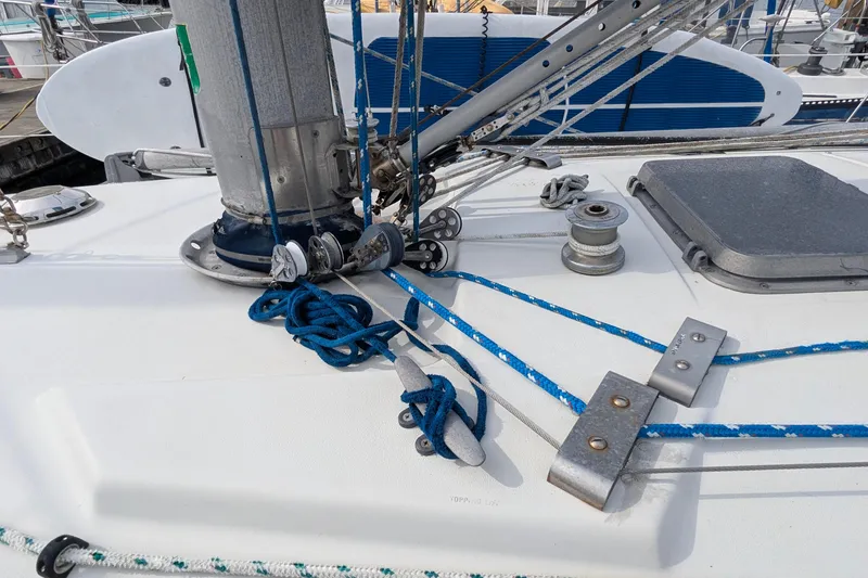 Slide: The Image of Inflatable dinghy docked beside a 1980 C&C 36 sailboat in a marina. - 19