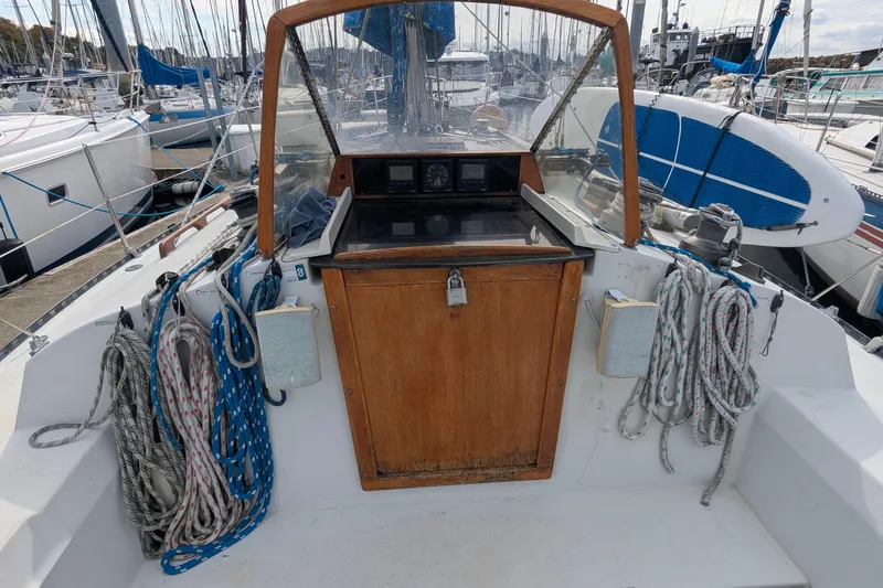 Slide: The Image of 1980 C&C 36 sailboat docked at marina with blue sail covers. - 2