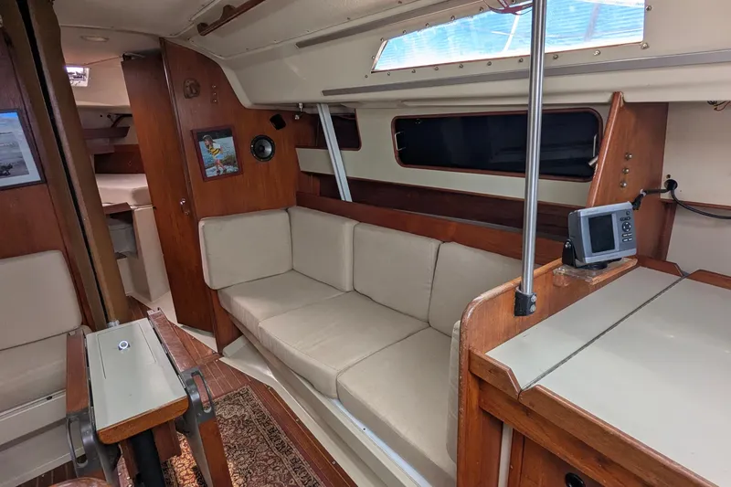 Slide: The Image of 1980 C&C 36 sailboat docked, displaying flags, under clear blue sky. - 4