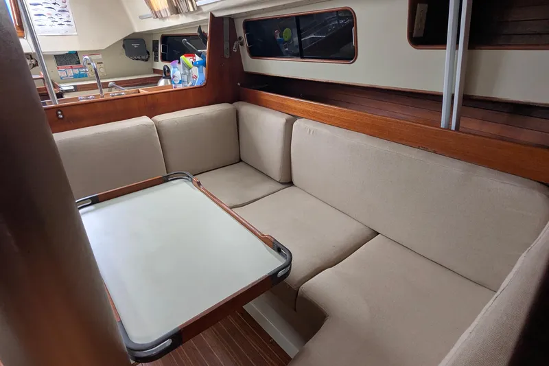 Slide: The Image of Interior of a 1980 C&C 36 sailboat with cozy seating and wooden accents. - 6