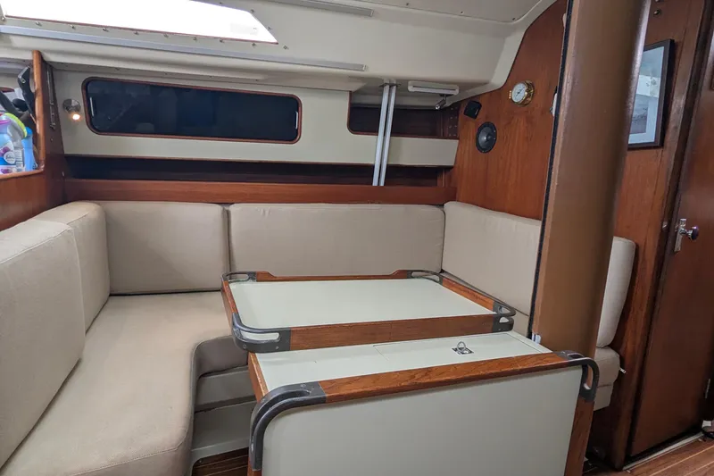 Slide: The Image of Interior of 1980 C&C 36 sailboat with beige seating and wooden accents. - 7