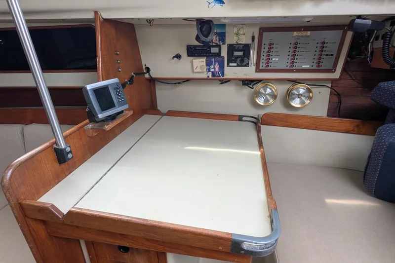 Slide: The Image of Interior of 1980 C&C 36 sailboat with beige cushions and wooden accents. - 8