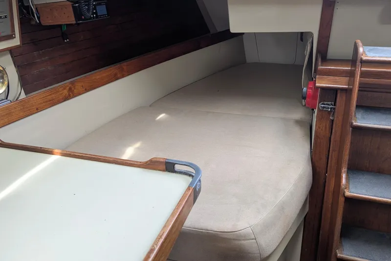 Slide: The Image of Interior of 1980 C&C 36 sailboat with beige seating and wooden accents. - 9