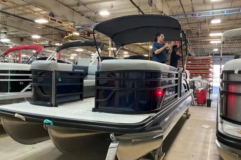 Slide: The Image of 2026 Bennington 23 SSRSF pontoon boat in a factory setting, under construction. - 10