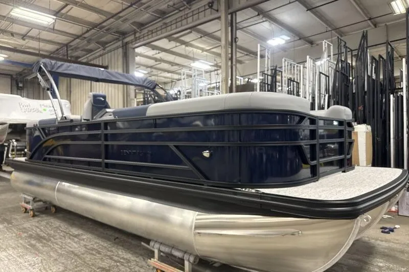 Slide: The Image of 2026 Bennington 23 SSRSF pontoon boat in a warehouse setting. - 16