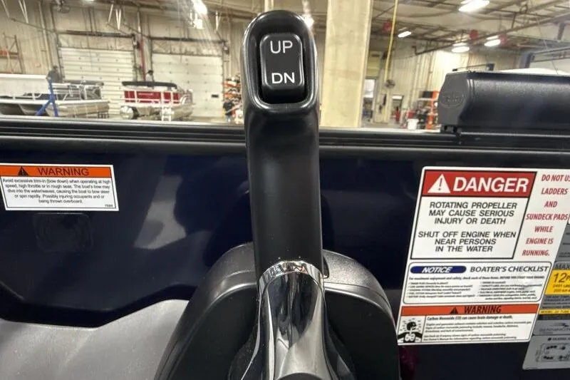 Slide: The Image of Throttle control lever with warning labels on a 2026 Bennington 23 SSRSF boat. - 22