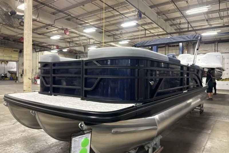 Slide: The Image of 2026 Bennington 23 SSRSF pontoon boat in a warehouse setting. - 4